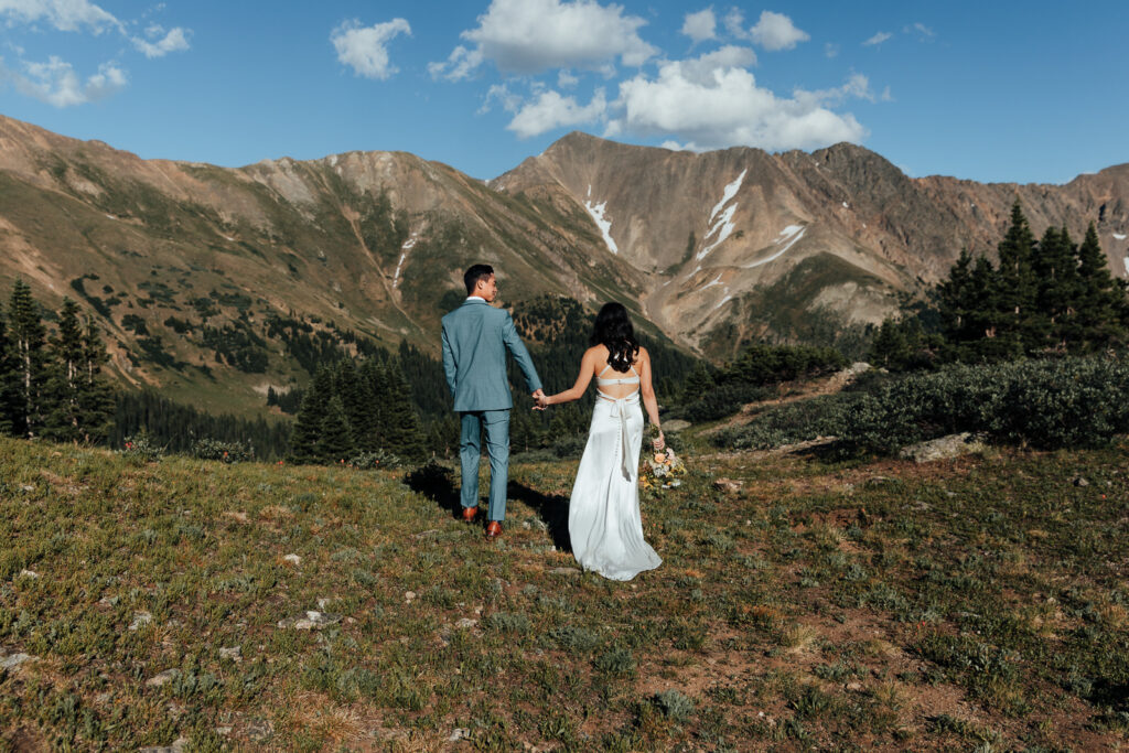 A couple holding hands and walking at Loveland Pass near Breckenridge, Colorado