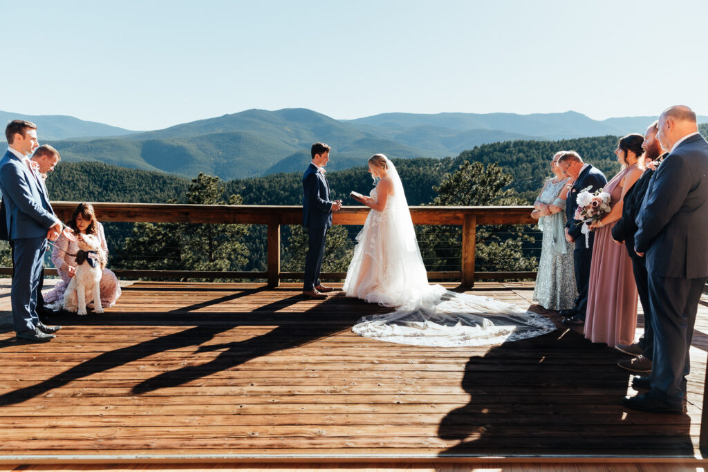 A couple exchanging vows at their Airbnb in Bailey, Colorado