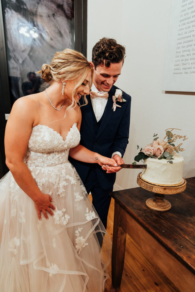 Couple cutting their cake at their Airbnb elopement in Bailey, Colorado