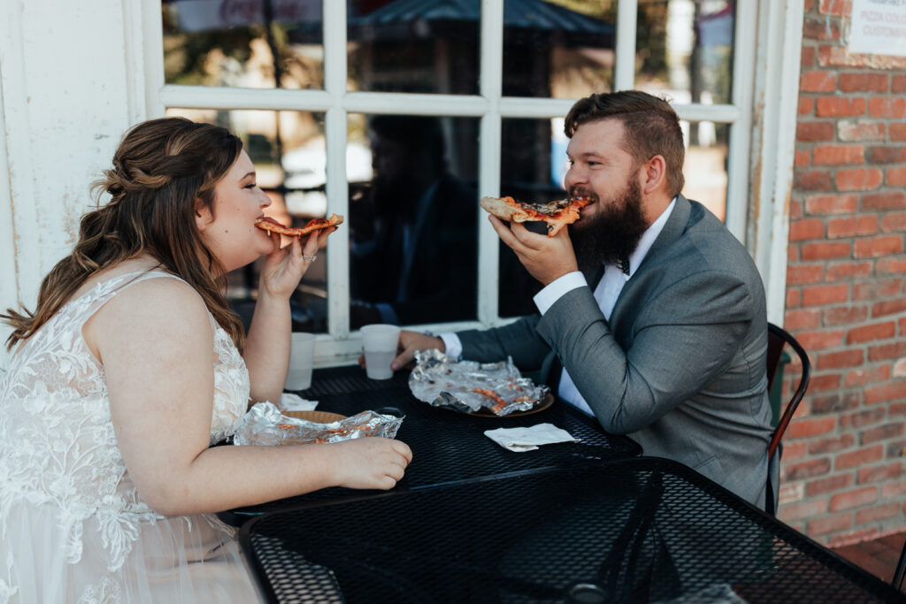 A couple sharing pizza on Pearl Street Mall in Boulder, Colorado
