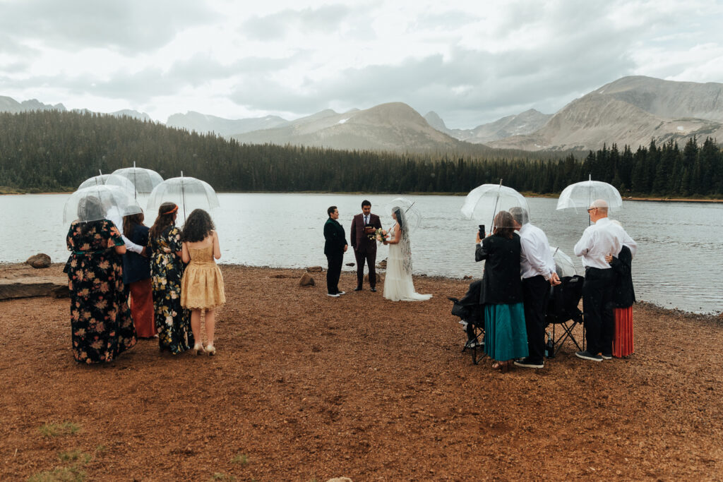 Couple exchanging vows in front of their family at Brainard Lake 