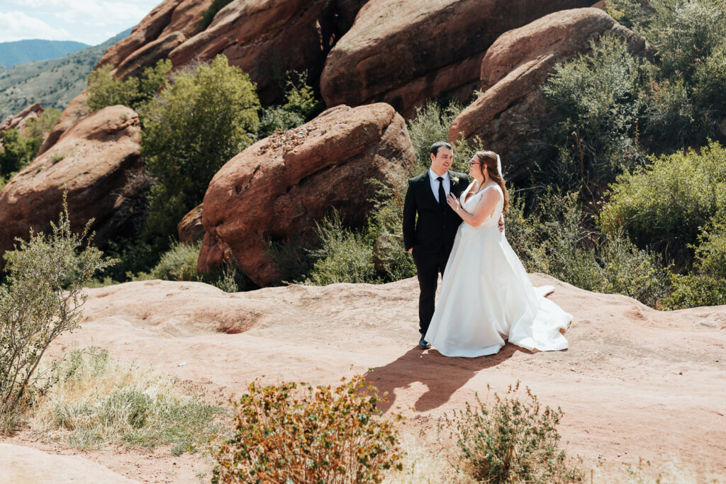 Couple smiling at each other at their elopement at Red Rocks Amphitheater near Denver
