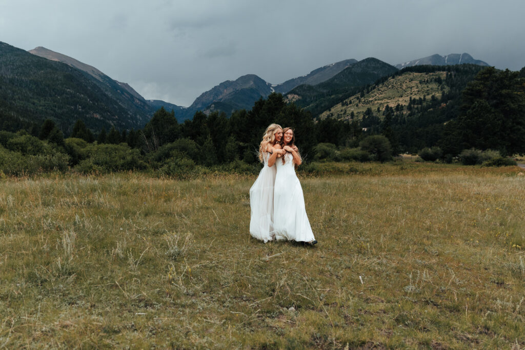 Couple hugging in a field at Rocky Mountain National Park in Estes Park