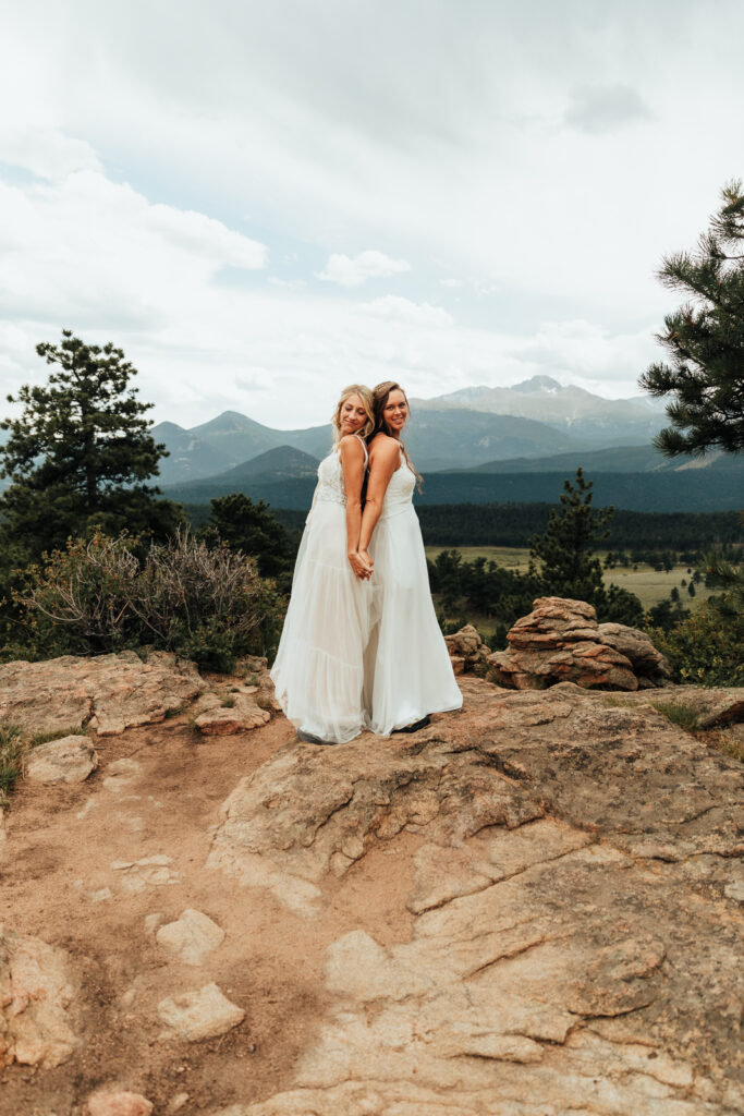 Couple smiling, standing back to back in Rocky Mountain National Park