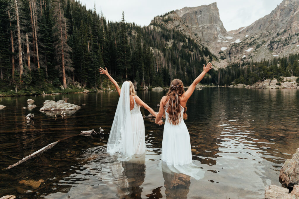 A couple standing in Dream Lake in Rocky Mountain National Park