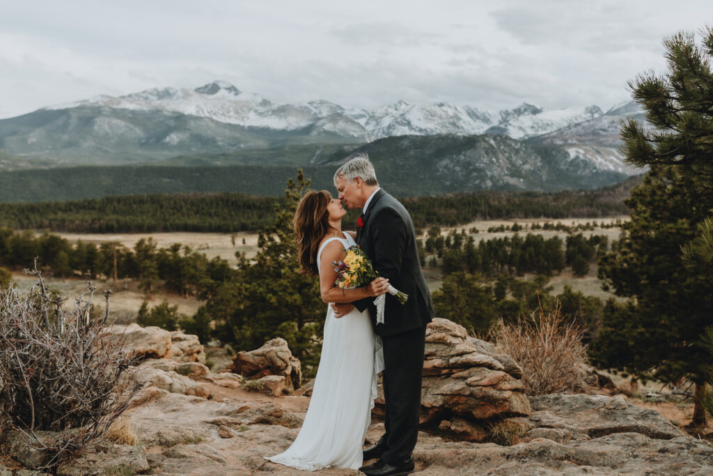 A couple kissing at 3M curve in Rocky Mountain National Park