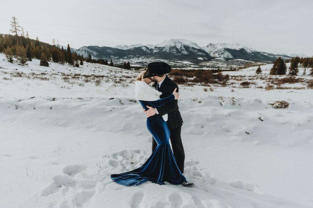 A couple kissing in a snowy field near Breckenridge, Colorado