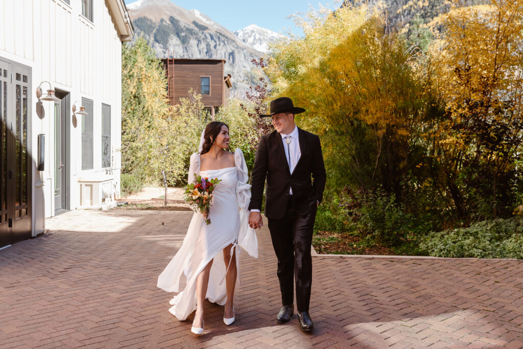 A couple holding hands and walking in Telluride, Colorado