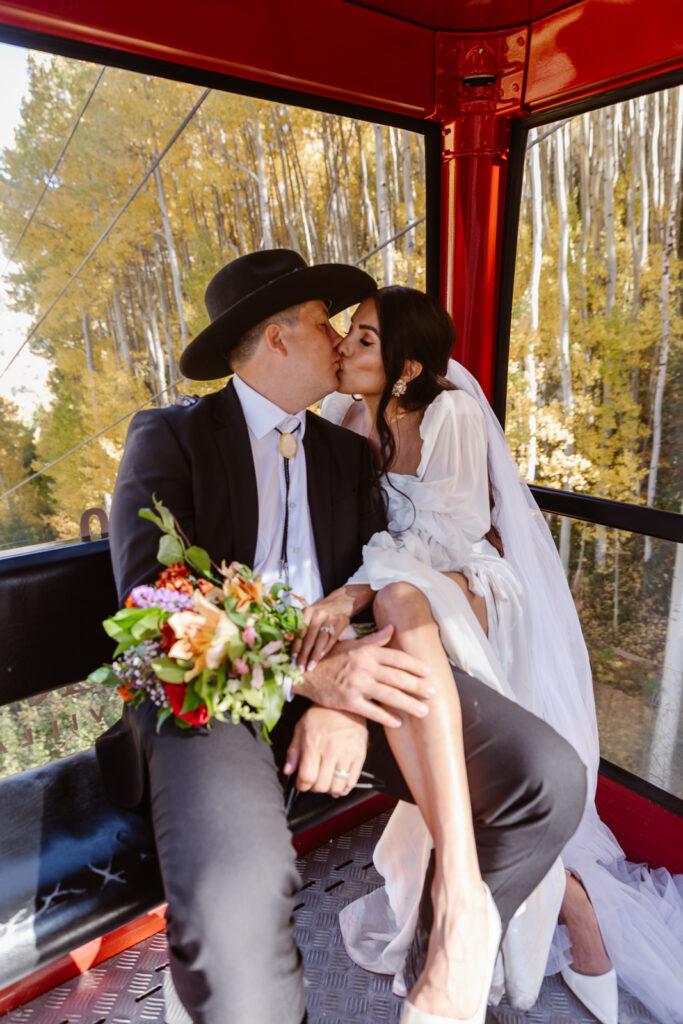 A couple kissing on a gondola ride in Telluride, Colorado