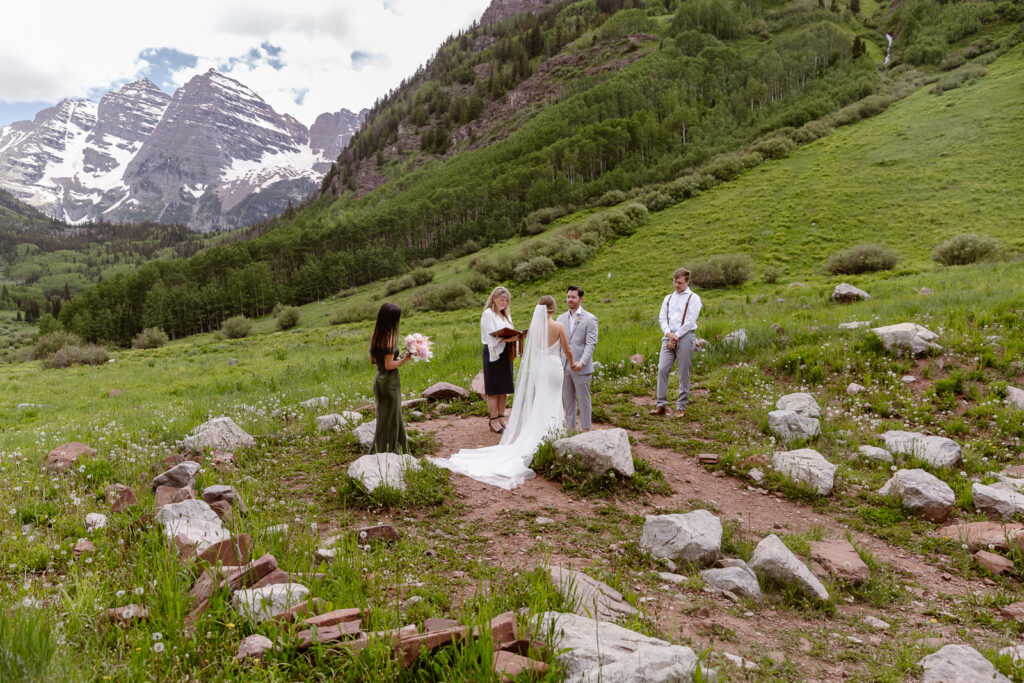 A couple exchanging vows at Maroon Bells in Aspen, Colorado