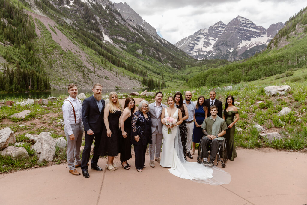 A bride and groom celebrating with their family after their elopement ceremony at Maroon Bells in Aspen, Colorado