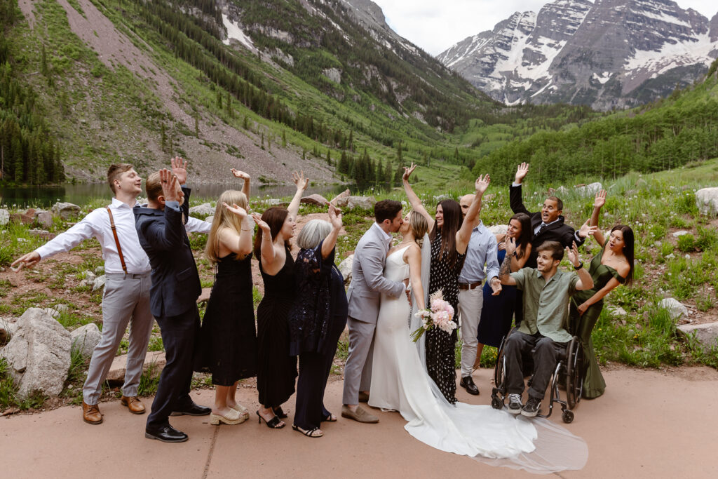 A bride and groom celebrating with their family after their elopement ceremony at Maroon Bells in Aspen, Colorado