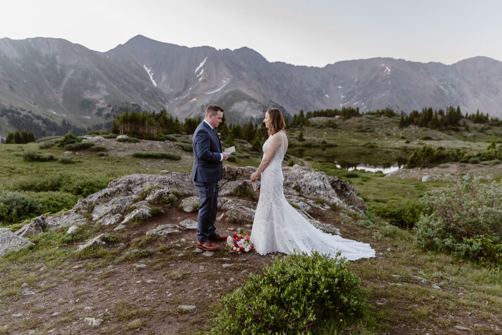 Couple exchanging vows at their intimate elopement ceremony at Loveland Pass in Colorado. 