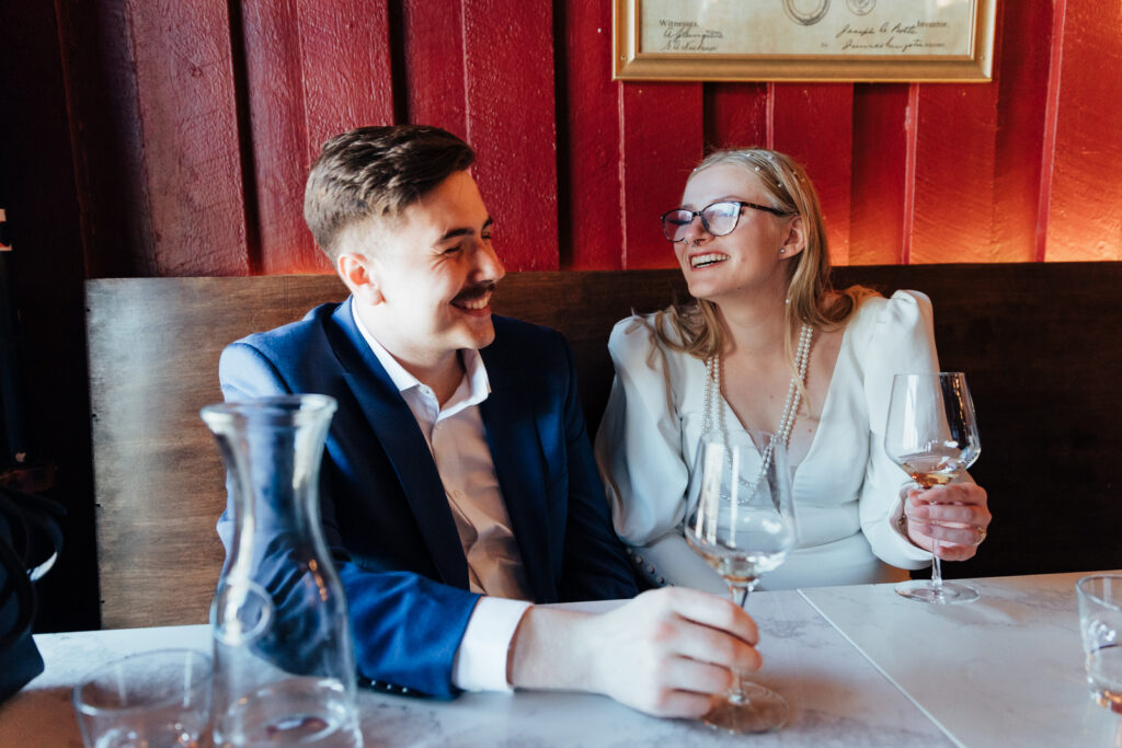 A couple laughing while sharing a glass of wine at a winery in Breckenridge, Colorado