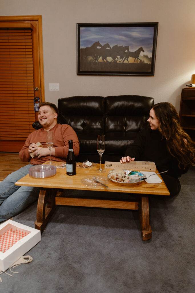 A couple playing games at their Airbnb to end their elopement day in Estes Park, Colorado