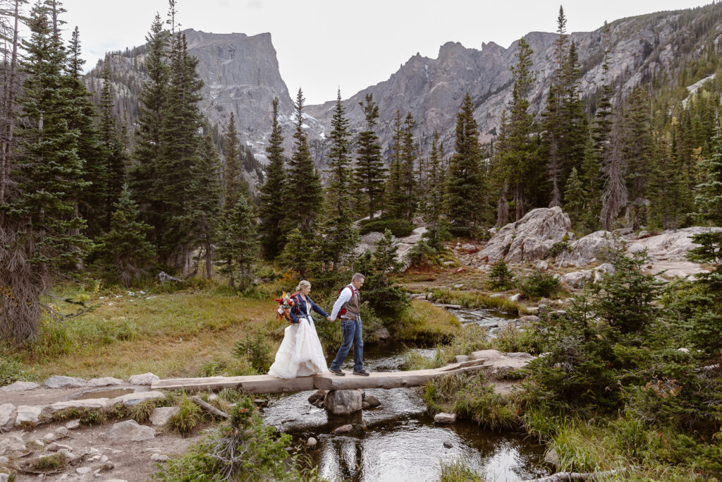 Couple hiking to Dream Lake on their elopement day in Rocky Mountain National Park. 